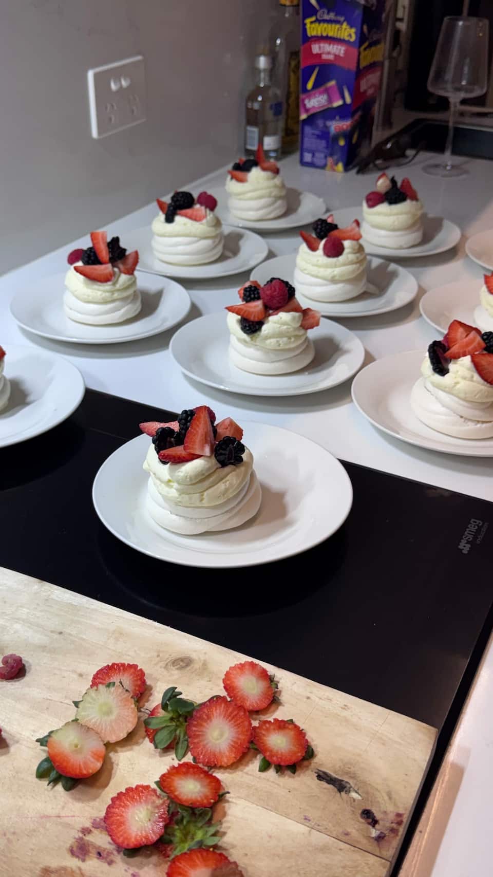 Individual pavlovas with berries and cream